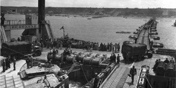 A Whale floating roadway leading to a Spud pier at Mulberry A off Omaha Beach